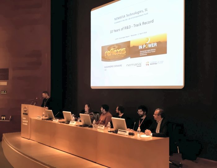 Room at the Repsol training centre with Nematia’s presentation “10 Years of R&D - Track Record” on the screen and a panel of speakers