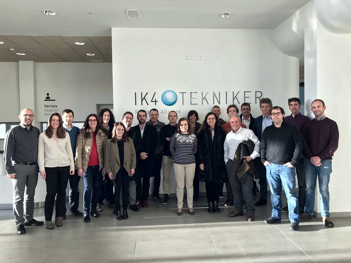 About twenty people pose in the Tekniker lobby